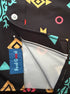 Close-up of a black button-up shirt with a colorful geometric print, featuring a blue 'Feel Good' brand label on the pocket.