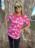 Woman wearing a pink shirt with llama and cactus pattern standing next to a tree.   A nod To Phish's song Llama.