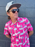 Man wearing a pink shirt with llama pattern and sunglasses, standing against a gray wall.   A nod To Phish's song Llama.